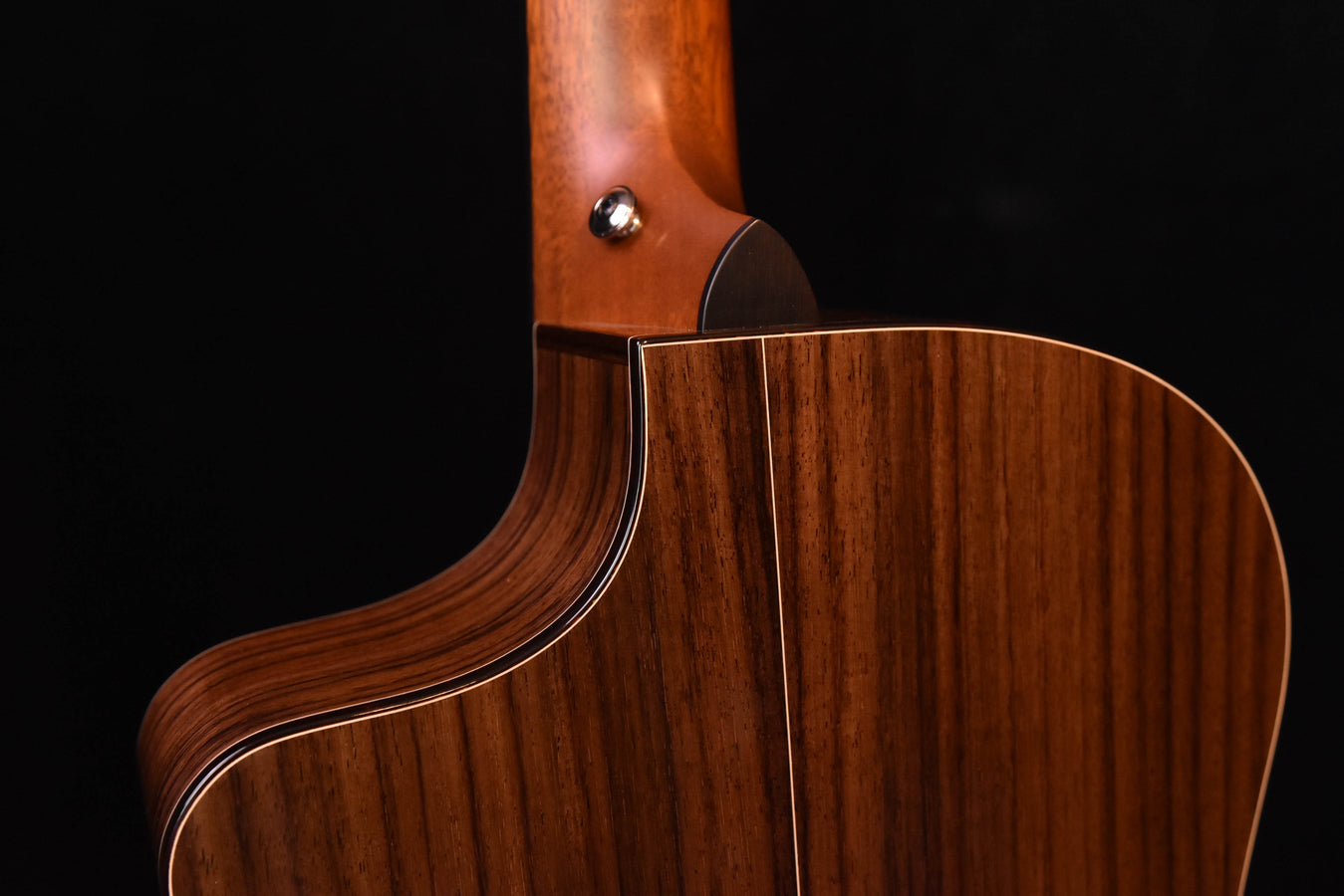Neck joint and upper bout of crossover acoustic guitar, natural wood