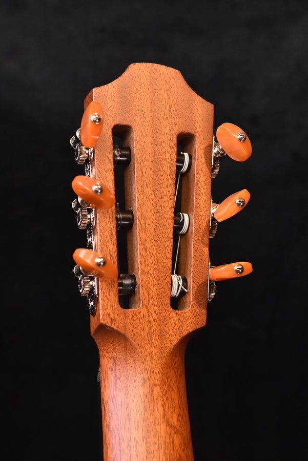 Guitar headstock with orange tuning pegs and chrome machine heads