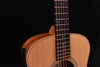 Acoustic guitar close-up: carved fretboard, body edge, round soundhole