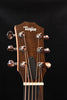 Taylor headstock with six chrome tuners and logo on dark wood