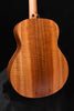 Figured koa acoustic guitar back, warm wood grain on curved body