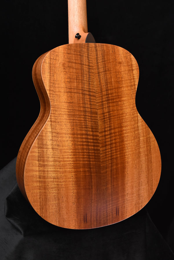 Figured koa acoustic guitar back, warm wood grain on curved body