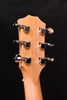 Taylor headstock close-up with six chrome tuning machines on light wood