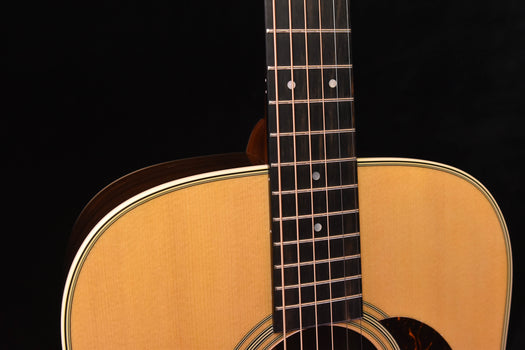 d-28e fretboard close-up with dot inlays and maple neck, upper body edge