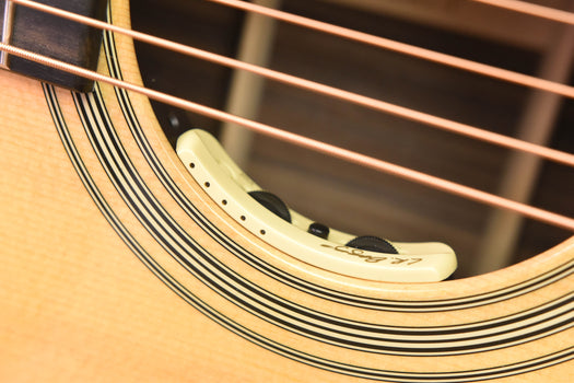 anthem pickup on acoustic guitar soundhole rosette area with white sensor body