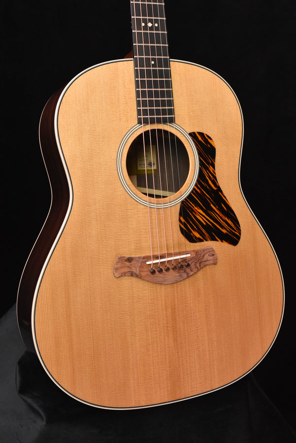 Acoustic guitar body with round sound hole, rosette and black patterned pickguard
