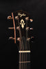Acoustic guitar headstock with Taylor logo and gold tuning pegs