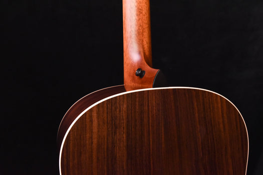 acoustic guitar upper back near neck joint with dark wood grain