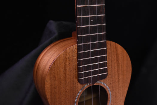 all-koa concert ukulele close-up of fretboard and upper body with sound hole