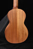 All-koa concert ukulele back view with central seam and wood grain
