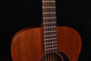 Neck and strings of satin all-mahogany acoustic guitar above the soundhole