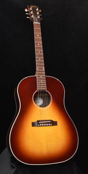 amber-brown acoustic guitar with soundhole rosette and pickguard, full front view