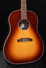 Acoustic guitar body close-up with soundhole ring, bridge plate, and strings