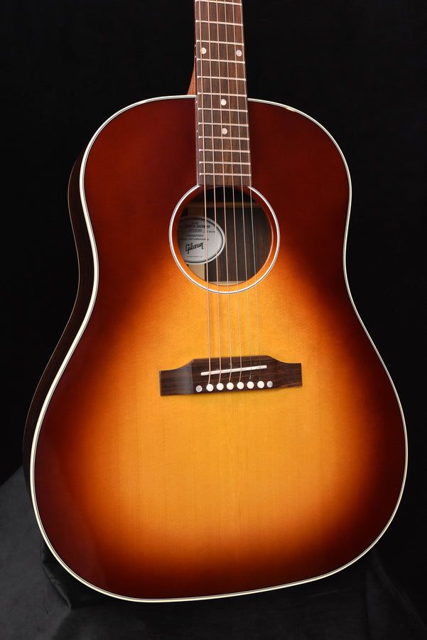 Acoustic guitar body close-up with soundhole ring, bridge plate, and strings