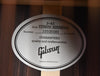 Guitar back label with J-45 Studio Rosewood text and guarantee stamp
