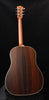 Brown wood acoustic guitar back with gold binding edge, full rear view