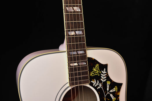 neck and upper bout of alpine white gloss acoustic guitar with hummingbird pickguard