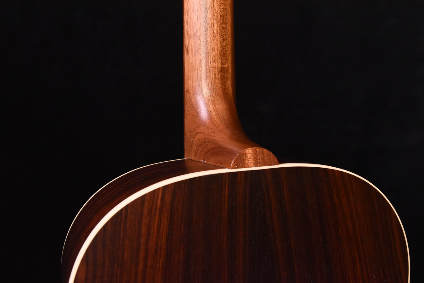 Acoustic guitar neck joint and upper back, close side view