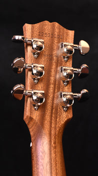acoustic guitar headstock with tuning pegs and stamped serial number