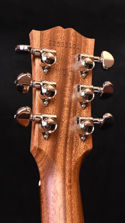 Acoustic guitar headstock with tuning pegs and stamped serial number