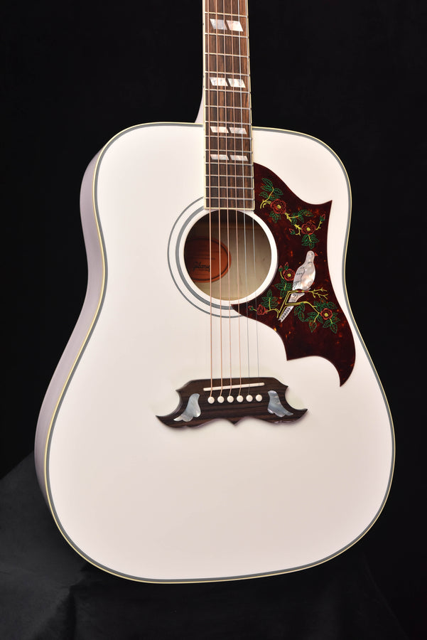 Alpine White acoustic-electric guitar body with dark floral pickguard and rosette soundhole