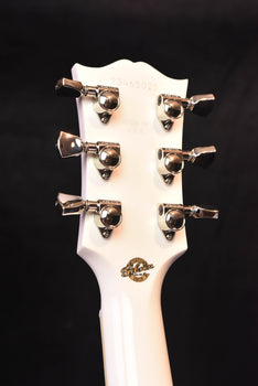 alpine white headstock back with six chrome tuning machines and logo badge