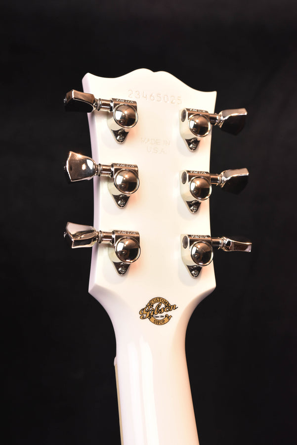 Alpine White headstock back with six chrome tuning machines and logo badge