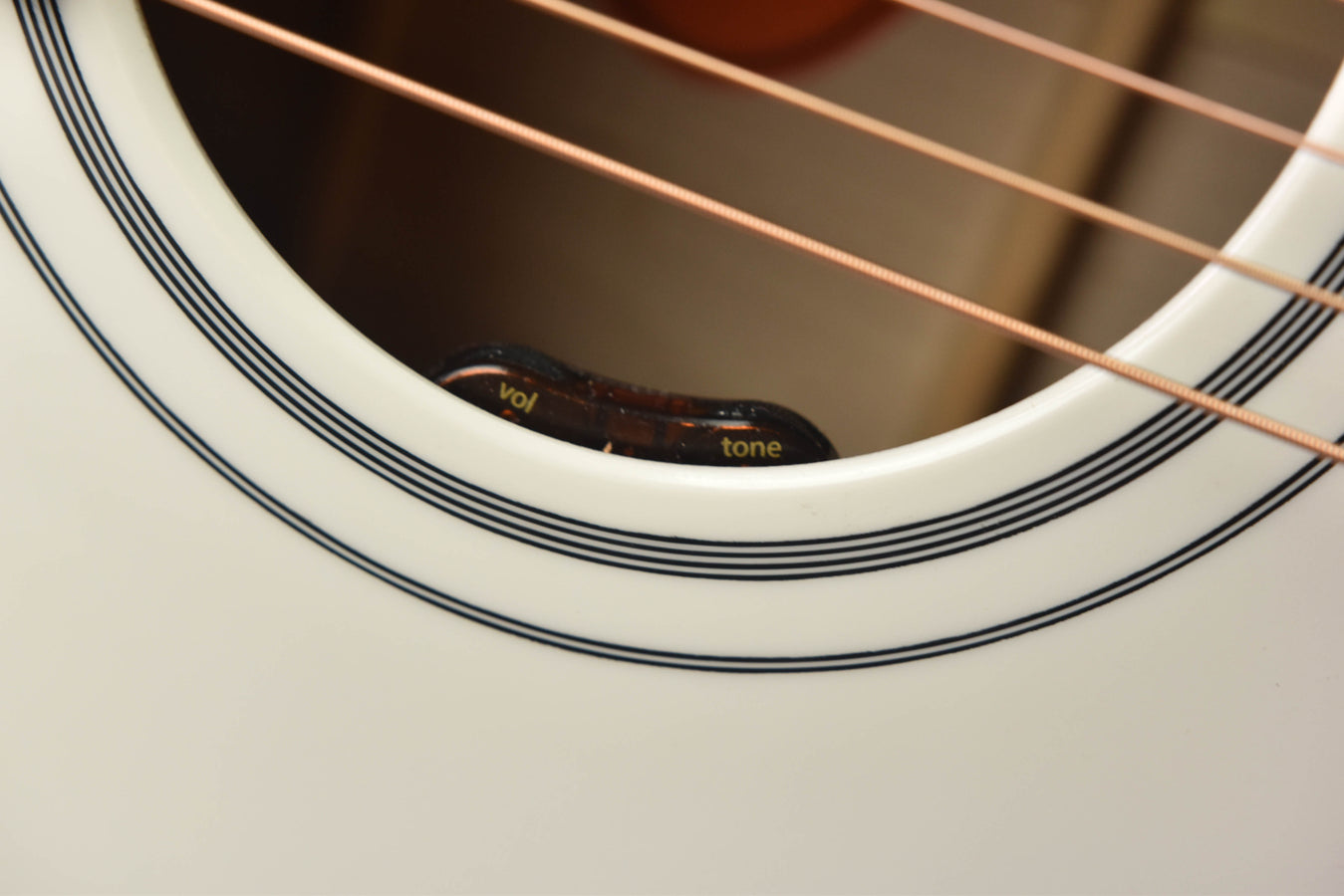 Soundhole rosette with stacked black-and-white inlay and 'tone' marking