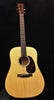 Light wood acoustic guitar with round sound hole, dark fretboard, and pickguard