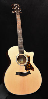 taylor 314ce acoustic-electric guitar with natural body and circular sound hole