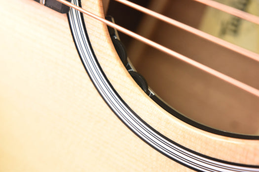 close-up of guitar body edge and binding near the soundhole