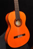 Flamenco guitar front view: orange top, black bridge, detailed circular rosette