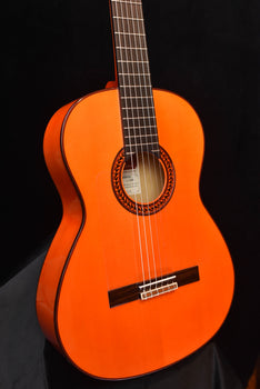 flamenco guitar front view: orange top, black bridge, detailed circular rosette