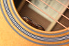 Acoustic guitar rosette detail with “Vol” and “tone” markings inside the sound hole