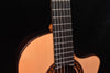 Close view of cutaway neck joint and upper fretboard over spruce soundboard