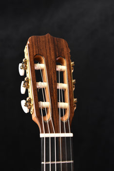 classical guitar headstock with tuning machines and carved nut detail