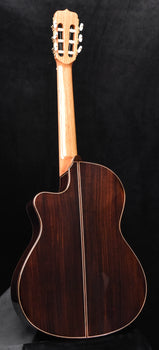 full view of classical cutaway guitar with spruce top and dark wood back