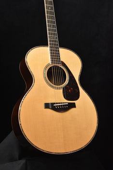 yamaha jumbo acoustic guitar front, soundhole rosette and bridge in view