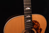 Jumbo acoustic guitar close-up of neck, fretboard, and soundhole edge rosette