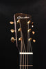 Jumbo acoustic guitar headstock with gold tuning machines and branded logo