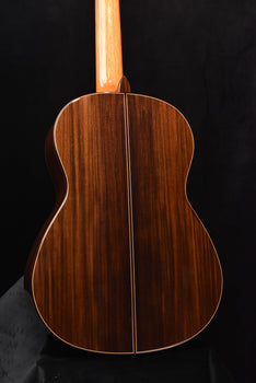 classical guitar back close-up showing center seam and curved body outline.