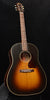 Acoustic guitar with sunburst finish, dark pickguard, and round sound hole