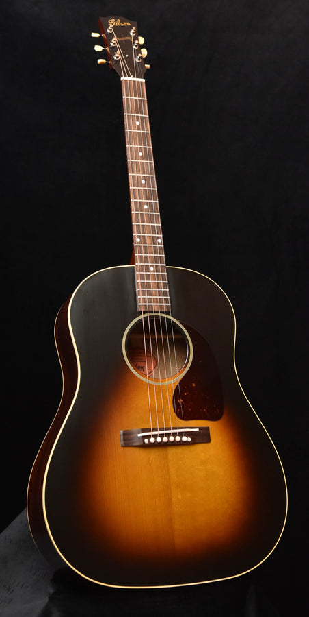 Acoustic guitar with sunburst finish, dark pickguard, and round sound hole