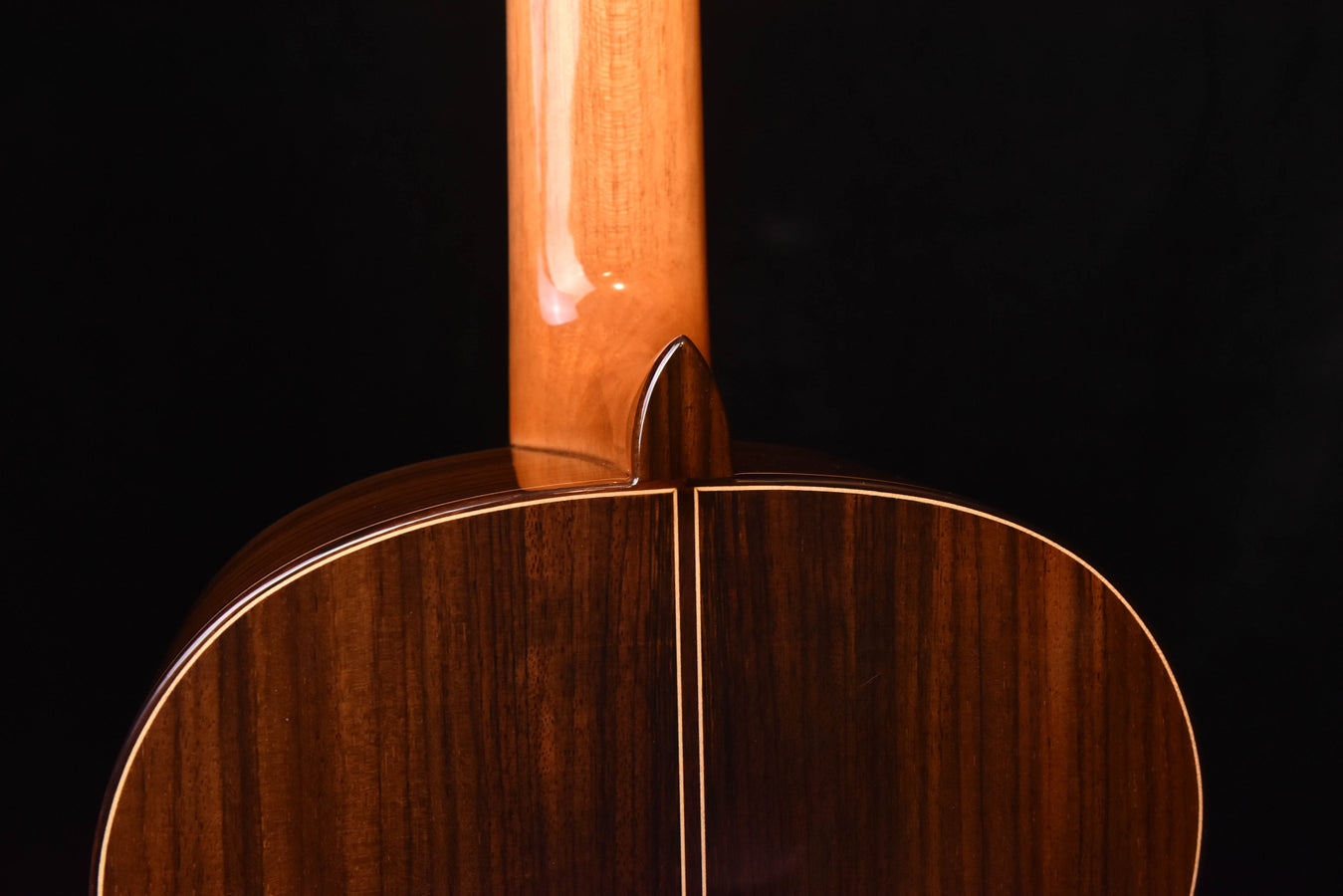 Classical guitar neck joint and upper bout, close-up of wood grain.