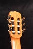 Classical guitar headstock with six tuning pegs, close-up.