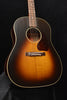 Acoustic guitar with sunburst finish, bridge and rosette visible