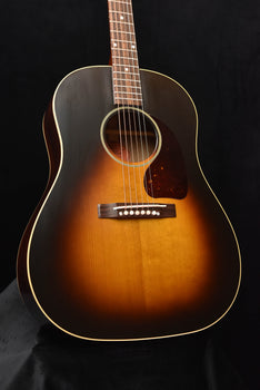 acoustic guitar with sunburst finish, bridge and rosette visible