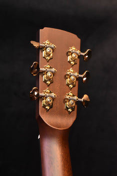 jumbo acoustic guitar headstock close-up with gold tuners and tuning keys