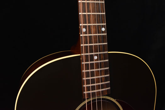 acoustic guitar neck with frets and headstock-to-body binding detail