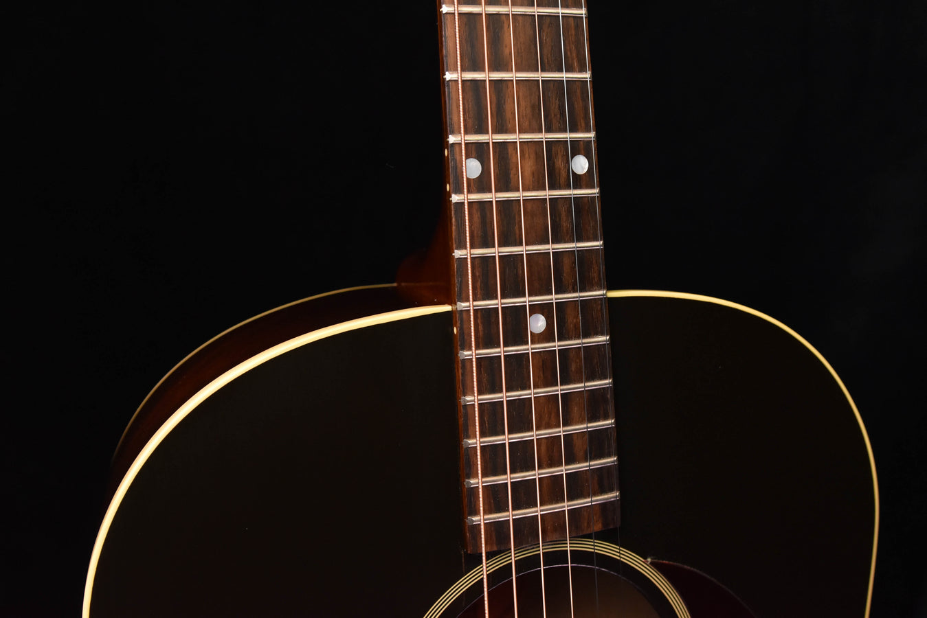 Acoustic guitar neck with frets and headstock-to-body binding detail